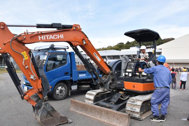 道路障害物除去車両に乗る児童